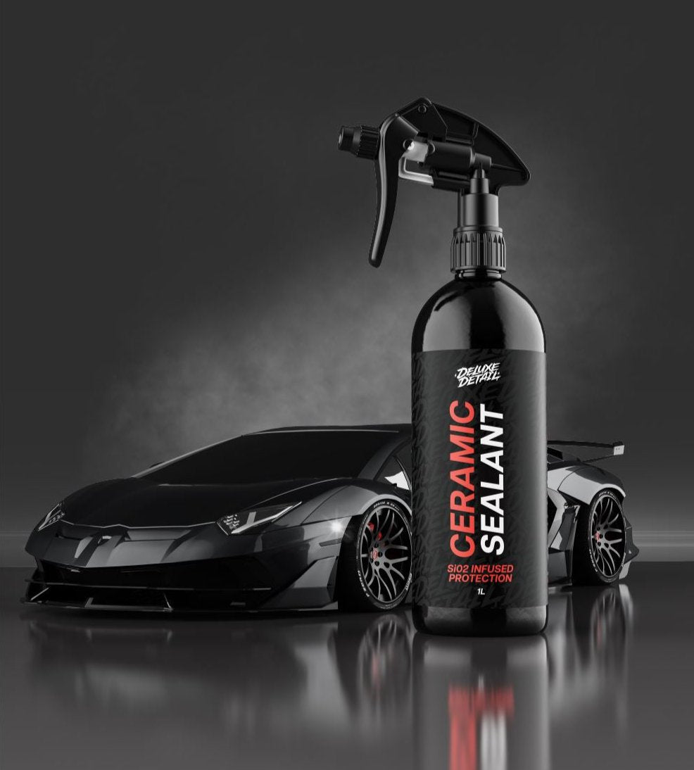 Deluxe Detail CERAMIC SEALANT bottle in the studio in front of a black supercar