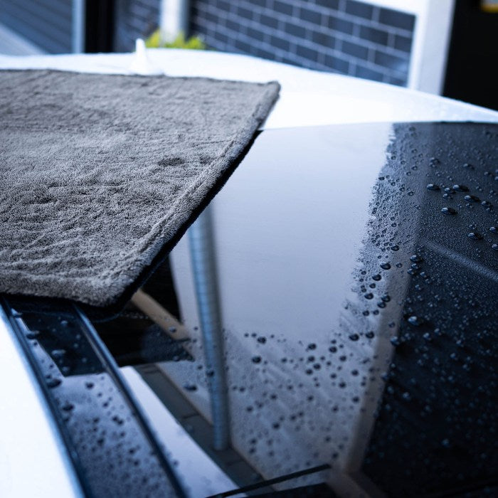 Dry Guy microfibre towel on the beaded, wet roof of a dark car