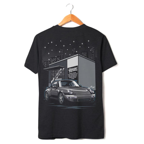 Deluxe Detail '911' t-shirt in black on a hanger, back print of a Porsche 911 outside the studio
