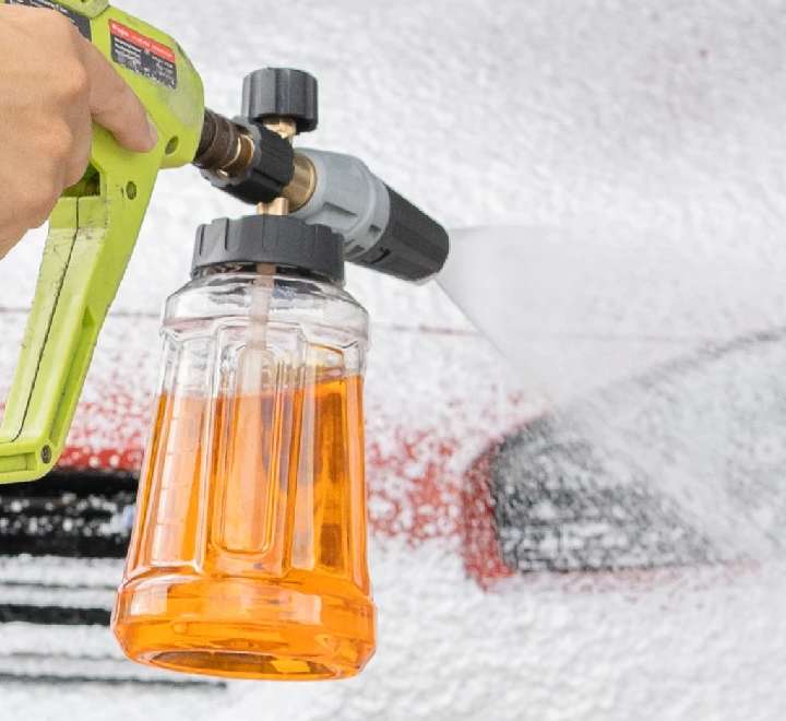 Snow foam lance on a pressure washer laying foam over a car during the pre-wash