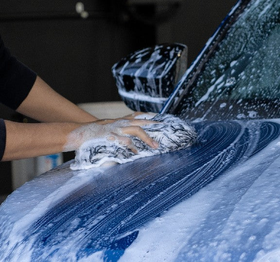 Washing a soapy car bonnet by hand with a Deluxe Detail microfibre wash pad
