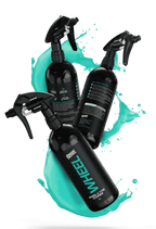 Four bottles of Deluxe Detail WHEEL cleaner in a teal liquid splash on a black background