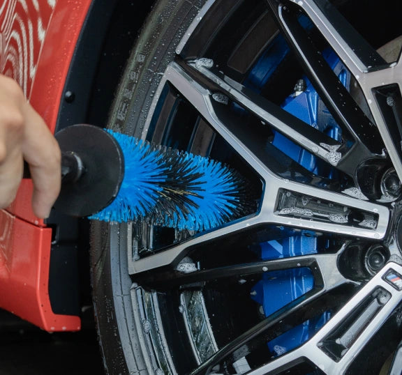 Cleaning inside a wet alloy wheel barrel with the thin blue barrel brush