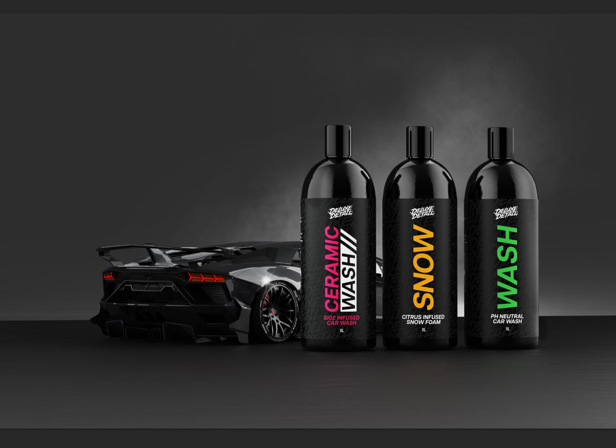 Deluxe Detail CERAMIC WASH, SNOW and WASH one litre bottles standing beside a Lamborghini in the studio