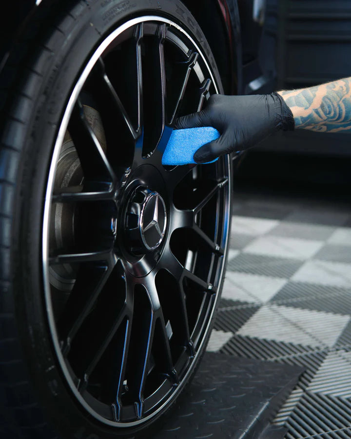 Coating a black Mercedes-AMG alloy wheel by hand with a microfibre applicator