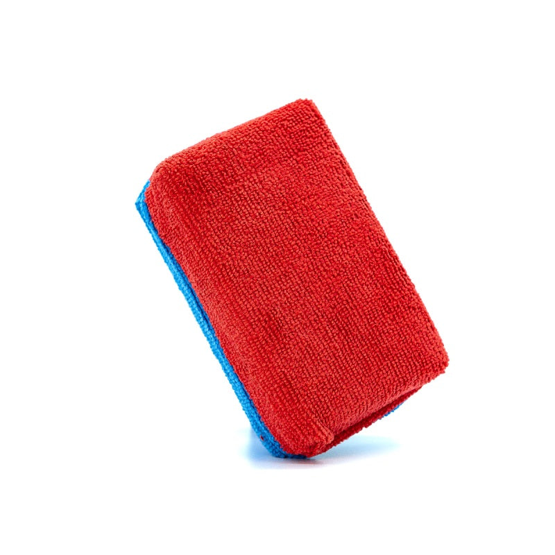 Large red microfibre applicator pad on a blue foam block